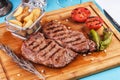 Grilled beef steak with grilled pepper, onion rings and tomatoes. Royalty Free Stock Photo