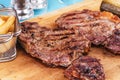 Grilled beef steak with grilled pepper, onion rings and tomatoes. Royalty Free Stock Photo