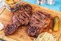 Grilled beef steak with grilled pepper, onion rings and tomatoes. Royalty Free Stock Photo