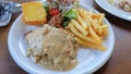 Grilled Beef Steak with Potato and Mushrooms. Garnished with Cherry Tomatoes and bread Royalty Free Stock Photo