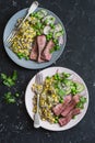 Grilled beef steak and quinoa corn salad on dark background, top view Royalty Free Stock Photo