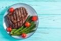 Grilled beef steak ribeye with cherry tomatoes and asparagus