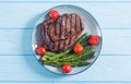 Grilled beef steak ribeye with cherry tomatoes and asparagus