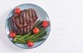 Grilled beef steak ribeye with cherry tomatoes and asparagus