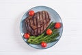 Grilled beef steak ribeye with cherry tomatoes and asparagus