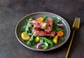 Grilled beef steak salad with arugula, potatoes, carrots, onions and pomegranate. Healthy eating. Diet Royalty Free Stock Photo