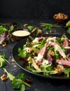 Grilled Beef Steak salad with pears, walnuts and greens vegetables and blue cheese sauce. healthy food. Royalty Free Stock Photo