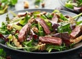 Grilled Beef Steak salad with pears, walnuts and greens vegetables and blue cheese sauce. healthy food. Royalty Free Stock Photo