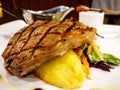 Grilled beef steak served with mashed potatoes and vegetables. Royalty Free Stock Photo