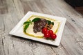 Grilled beef steak with tomatoes and mushrooms Royalty Free Stock Photo