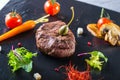 Grilled Beef steak with vegetable decoration. Grilled porterhouse steak on slate board. Royalty Free Stock Photo