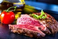 Grilled Beef steak with vegetable decoration. Grilled porterhouse steak on slate board. Royalty Free Stock Photo