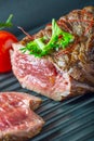 Grilled Beef steak with vegetable decoration. Grilled porterhouse steak on slate board. Royalty Free Stock Photo