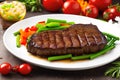 Grilled beef steak with vegetable on the flaming grill Royalty Free Stock Photo