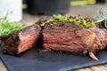 Grilled beef steak on wooden table top. Healthy food concept. Beef cut outdoors, garden kitchen, bbq grill patio Royalty Free Stock Photo