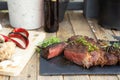 Grilled beef steak on wooden table top. Healthy food concept. Beef cut outdoors, garden kitchen, bbq grill patio Royalty Free Stock Photo