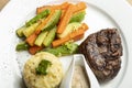 Grilled beef steaks with spices with vegetables, mashed potato, and mushroom sauce Royalty Free Stock Photo