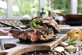 Grilled beef steaks with spices on wooden cutting board in the kitchen Royalty Free Stock Photo