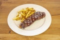 Grilled beef tenderloin garnished with coarse salt and a side of French fries