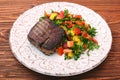 Grilled beefsteaks and vegetables