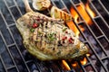 Grilled bone-in pork chop, pork steak, tomahawk in a rosemary-garlic marinade on a flaming grill