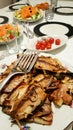 Grilled Bonito Palamut Fish Slices at dinner table.