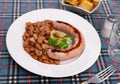 Grilled botifarra with stewed fava beans, onion slice, parsley