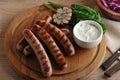 Grilled bratwurst sausages with sauce, spinach and garlic Royalty Free Stock Photo