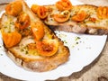 Grilled bruschetta with Italian tomatoes, orange color, very good and lasting, seasoned with olive oil and oregano