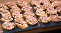 Grilled bruschetta with sausage salad and dill on a slate tray Royalty Free Stock Photo