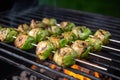 grilled brussels sprouts on a metal skewer on a grill