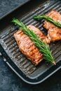 Grilled buffalo beef steak with rosemary in black grill pan on the table, close-up Royalty Free Stock Photo