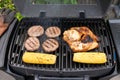 Grilled burgers, chicken, and corn on barbecue grill Royalty Free Stock Photo