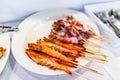 Grilled butter shrimps skewer in stick and Squid Sticks on White Plate Royalty Free Stock Photo