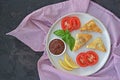 Grilled cheese with chopped tomatoes on a white ceramic plate. Served with rhubarb chutney