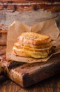 Grilled cheese sandwich with chili pepper on paper on wooden board. Selective focus. Royalty Free Stock Photo