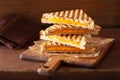 Grilled cheese sandwich on rustic brown background