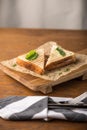 Grilled cheese toast decorated with spinach on wooden board on the table Royalty Free Stock Photo