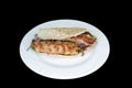 Grilled chicken Adana in Cypriot pitta bread in a white plate