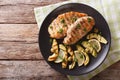 Grilled chicken breast with avocado, lemon and olive close-up. h