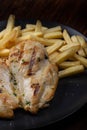 grilled chicken breast cut with french fries Royalty Free Stock Photo