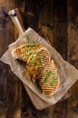 Grilled chicken breast on dark wooden background