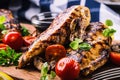 Grilled chicken breast in different variations with cherry tomatoes, mushrooms, herbs, cut lemon on a wooden board or teflon pan. Royalty Free Stock Photo