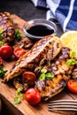 Grilled chicken breast in different variations with cherry tomatoes, mushrooms, herbs, cut lemon on a wooden board or teflon pan. Royalty Free Stock Photo