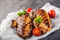 Grilled chicken breast in different variations with cherry tomatoes, mushrooms, herbs, cut lemon on a wooden board or teflon pan.