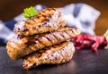 Grilled chicken breast in different variations with cherry tomatoes, mushrooms, herbs, cut lemon on a wooden board or teflon pan. Royalty Free Stock Photo