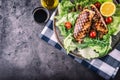 Grilled chicken breast in different variations with lettuce salad cherry tomatoes mushrooms herbs cut lemon on a wooden board or Royalty Free Stock Photo