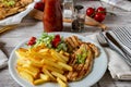 Grilled chicken breast with french fries Royalty Free Stock Photo