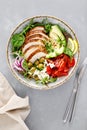 Grilled chicken breast and fresh vegetable salad with tomatoes, feta cheese, olives and avocado. Top view Royalty Free Stock Photo