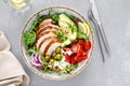 Grilled chicken breast and fresh vegetable salad with tomatoes, feta cheese, olives and avocado. Top view Royalty Free Stock Photo